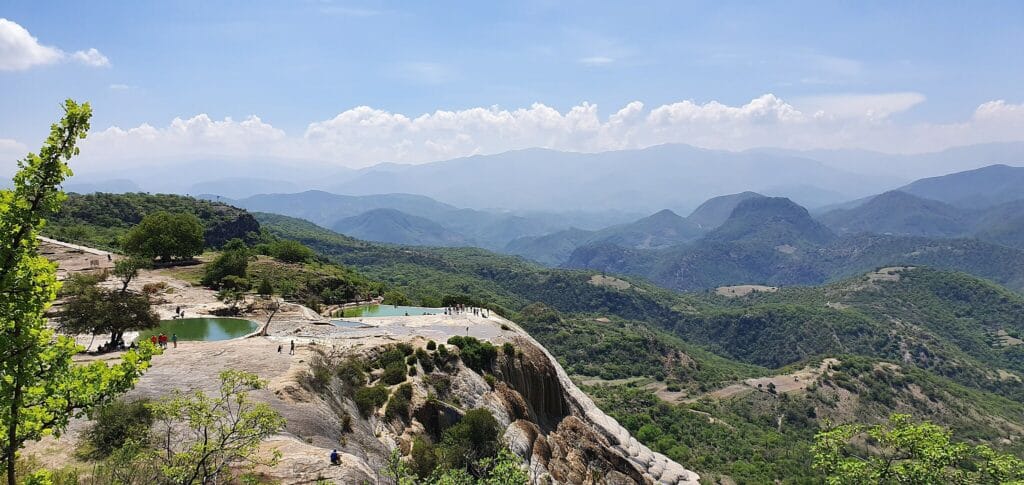 Lanscape image of mountains, forest, and cascading lake