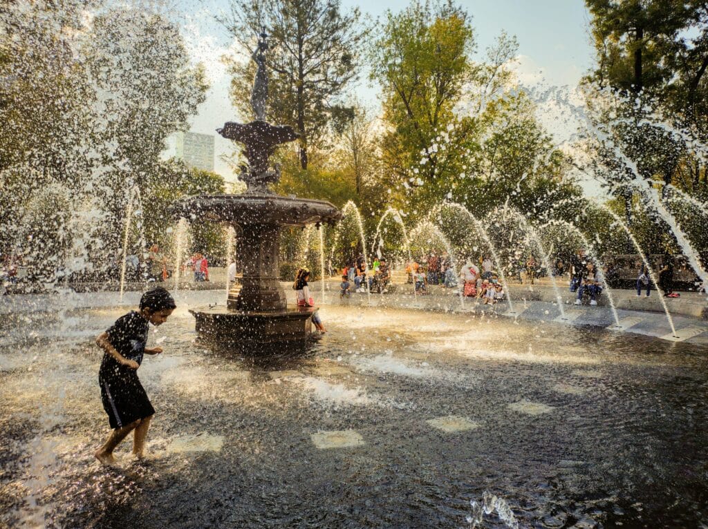 Kids playing in fountain in Mexico