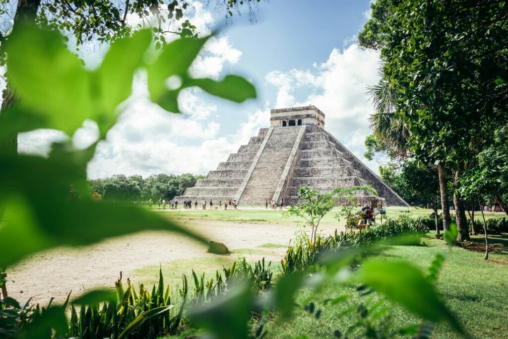 Chichen itza, mayan ruin, framed by foliage